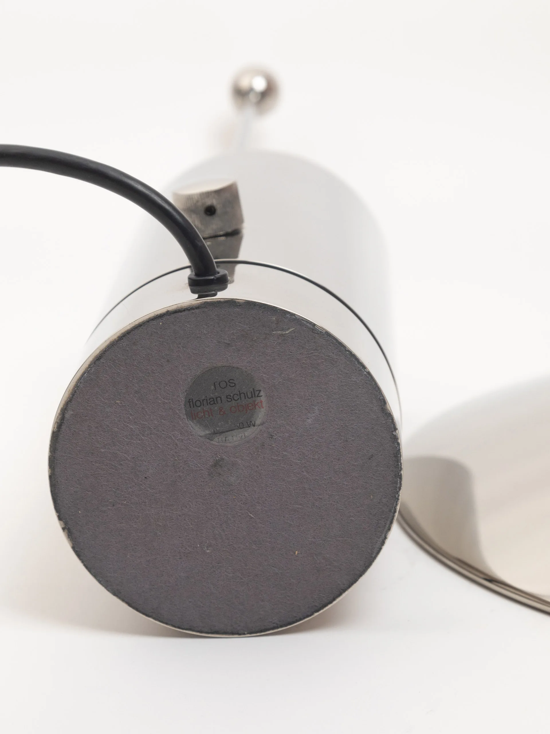 Rare "TOS" nickel-plated metal table lamp by Florian Schulz. Cylindrical fully chrome-plated base with an adjustable chrome reflector plate. Produced between the 1980s and 1990s. Stamp / original brand's sticker